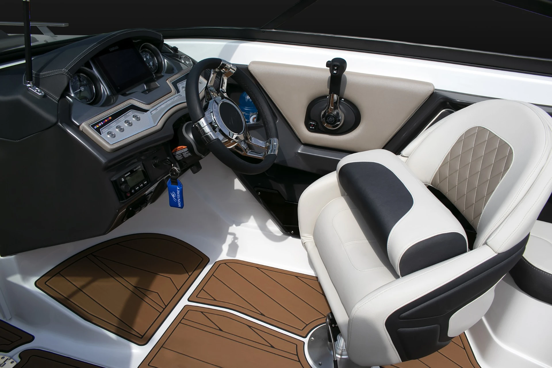 Driver’s console with stainless steel wheel, digital displays, throttle controls, and diamond-stitched captain’s chair