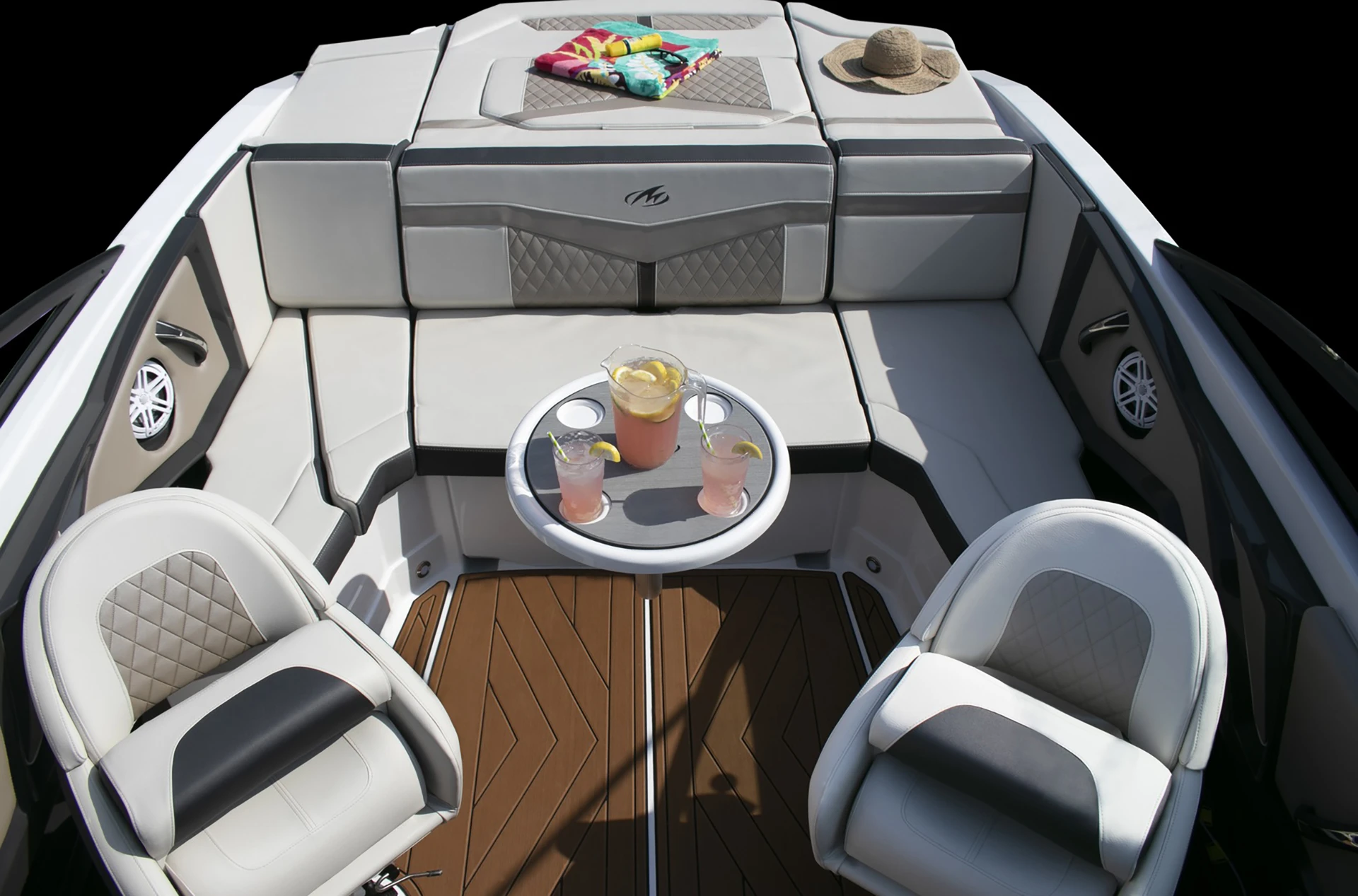 Spacious rear cockpit with wraparound seating, dual captain’s chairs, teak-style flooring, and a refreshment table with drinks