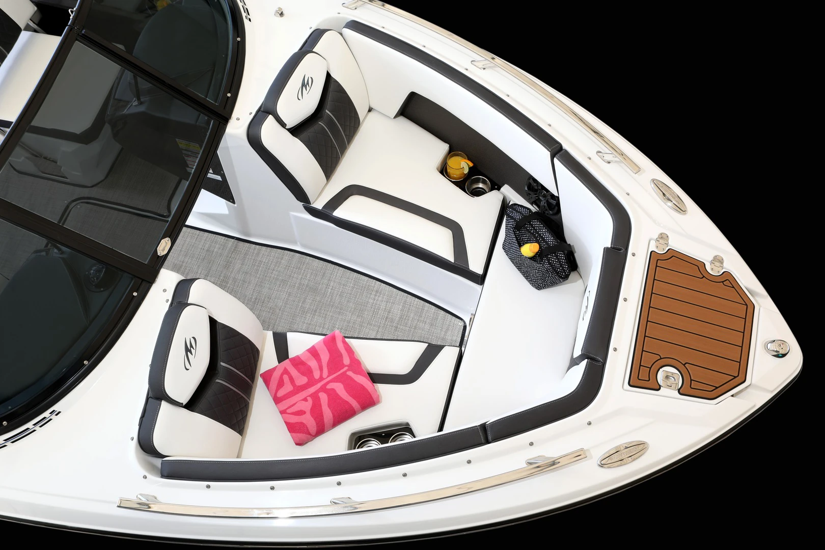 Overhead view of the bow lounge with diamond-stitched cushions, cupholders, storage, and accessories placed on the seats