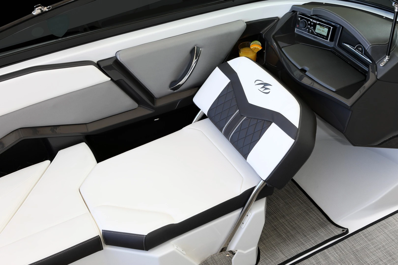 Adjustable companion seat in lounge position with diamond-stitched accents, side armrest, and nearby audio system