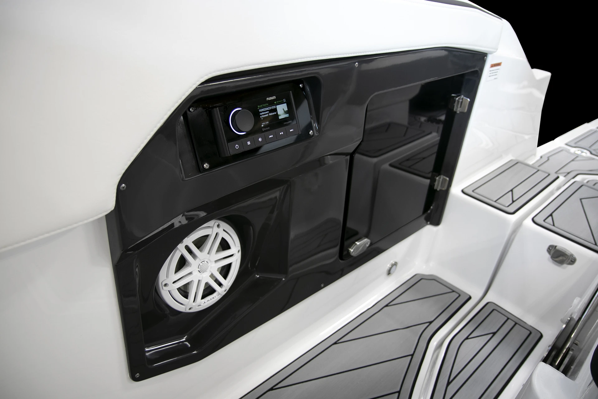 Close-up of the starboard side stereo system and JL Audio speaker integrated into the cockpit, highlighting premium sound and entertainment options
