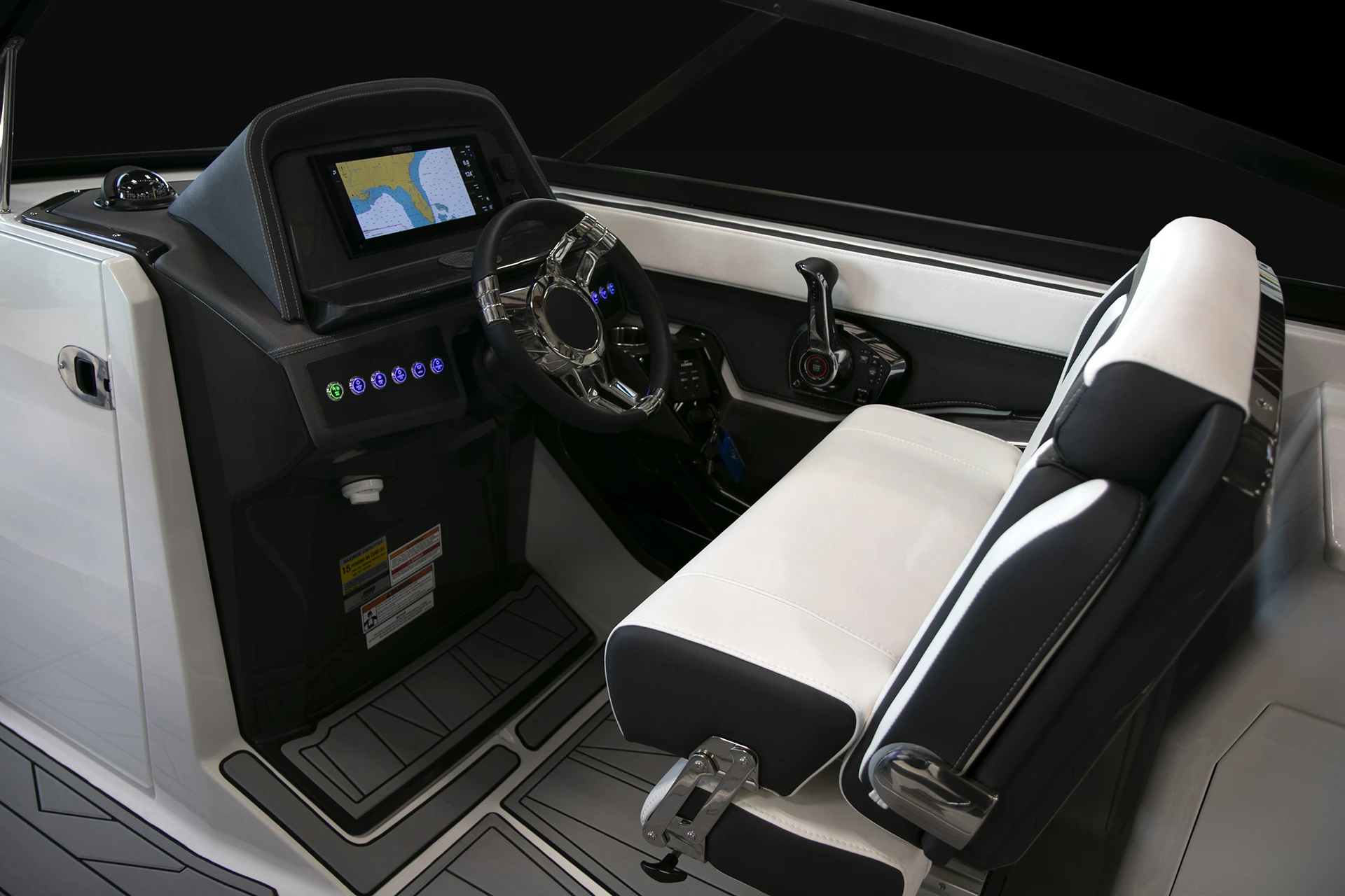 Captain’s helm seat and dashboard with Simrad navigation display, ergonomic controls, and throttle for precision handling