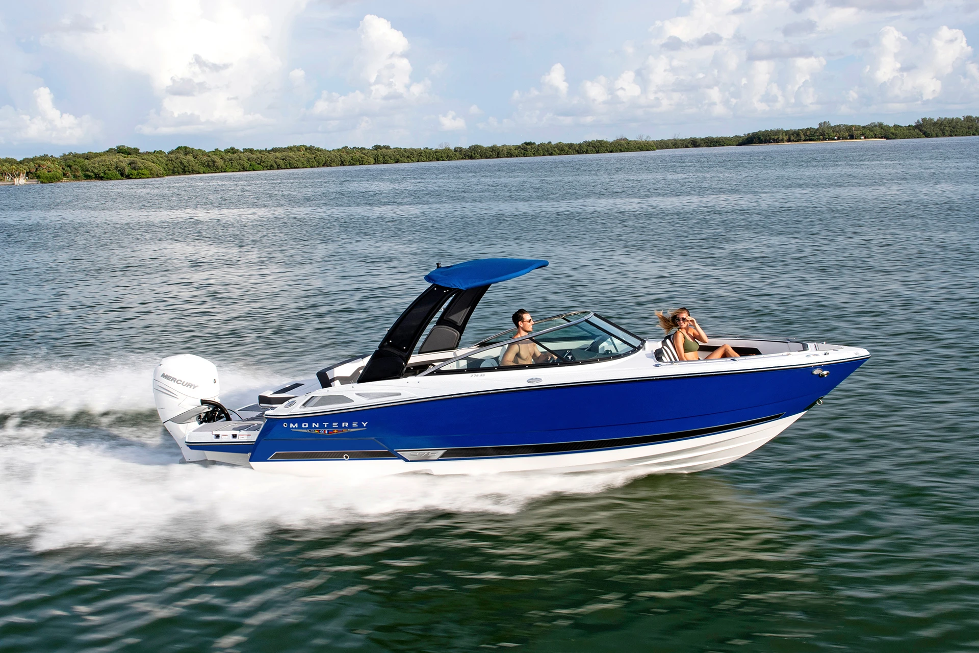 Starboard running shot of the Monterey 275SS powered by Mercury outboard, canopy extended