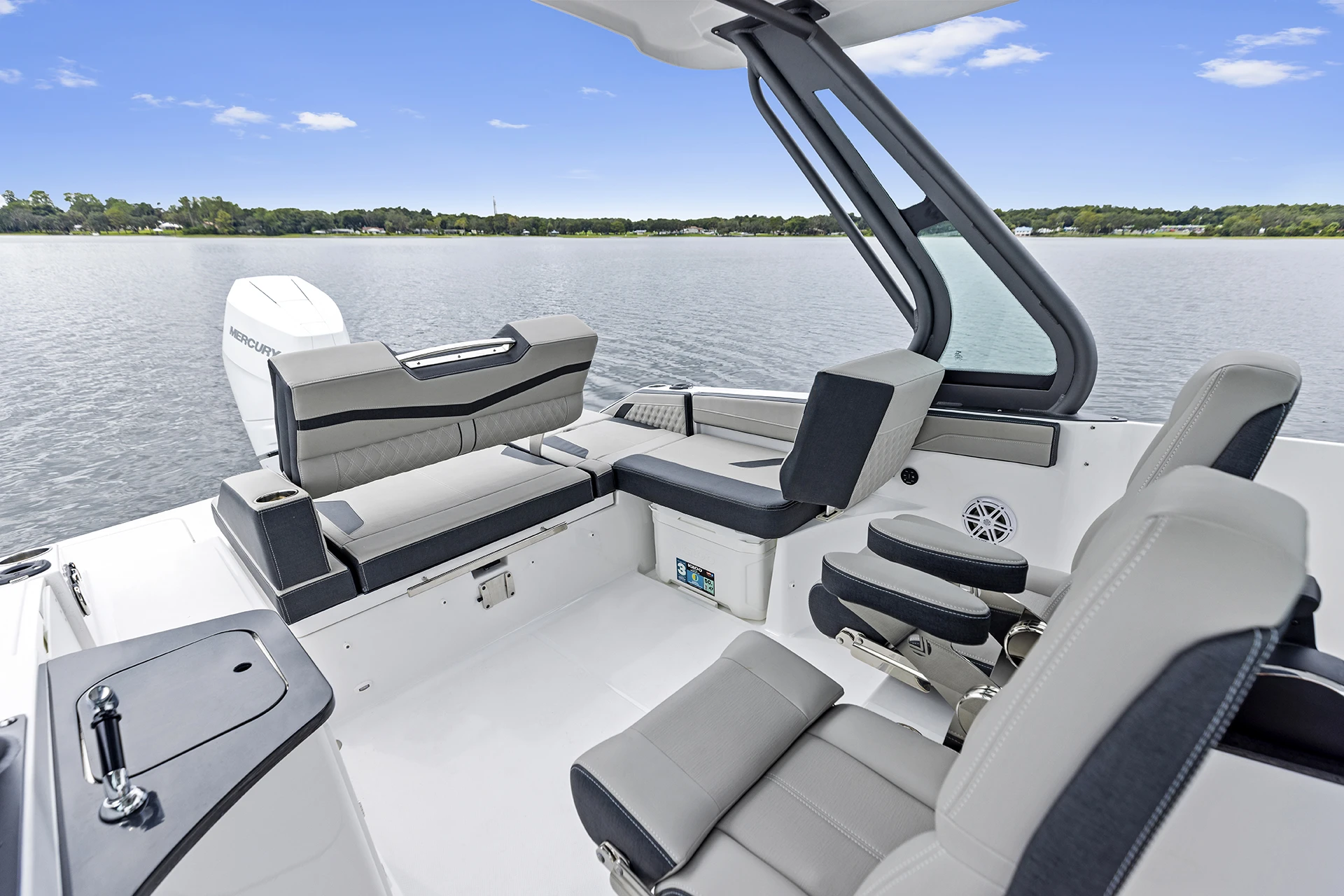 Cockpit seating layout with Yeti cooler and dual helm chairs on the Monterey Elite 27 OB