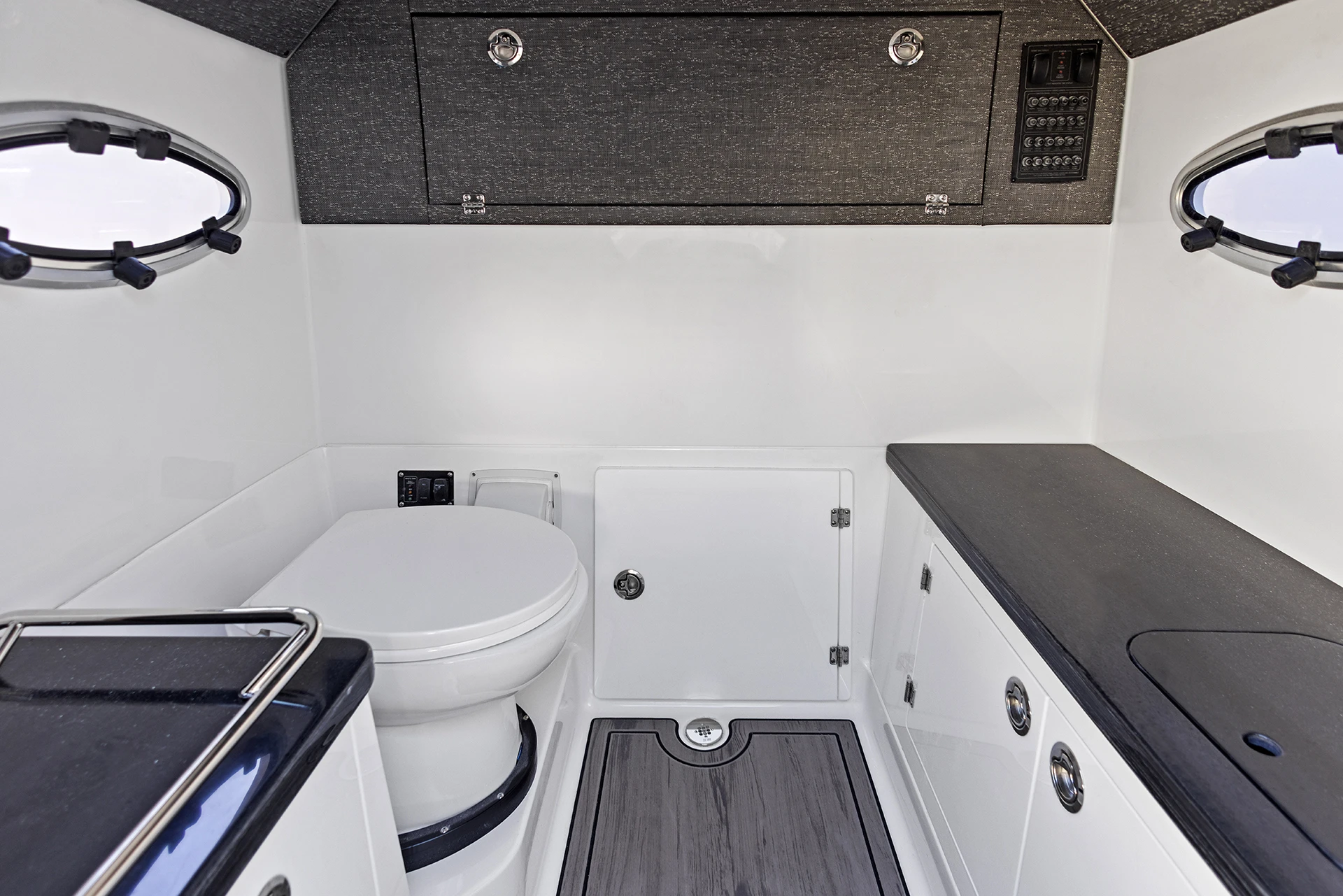 Head compartment with toilet, counter, and storage inside the Monterey Elite 27 O