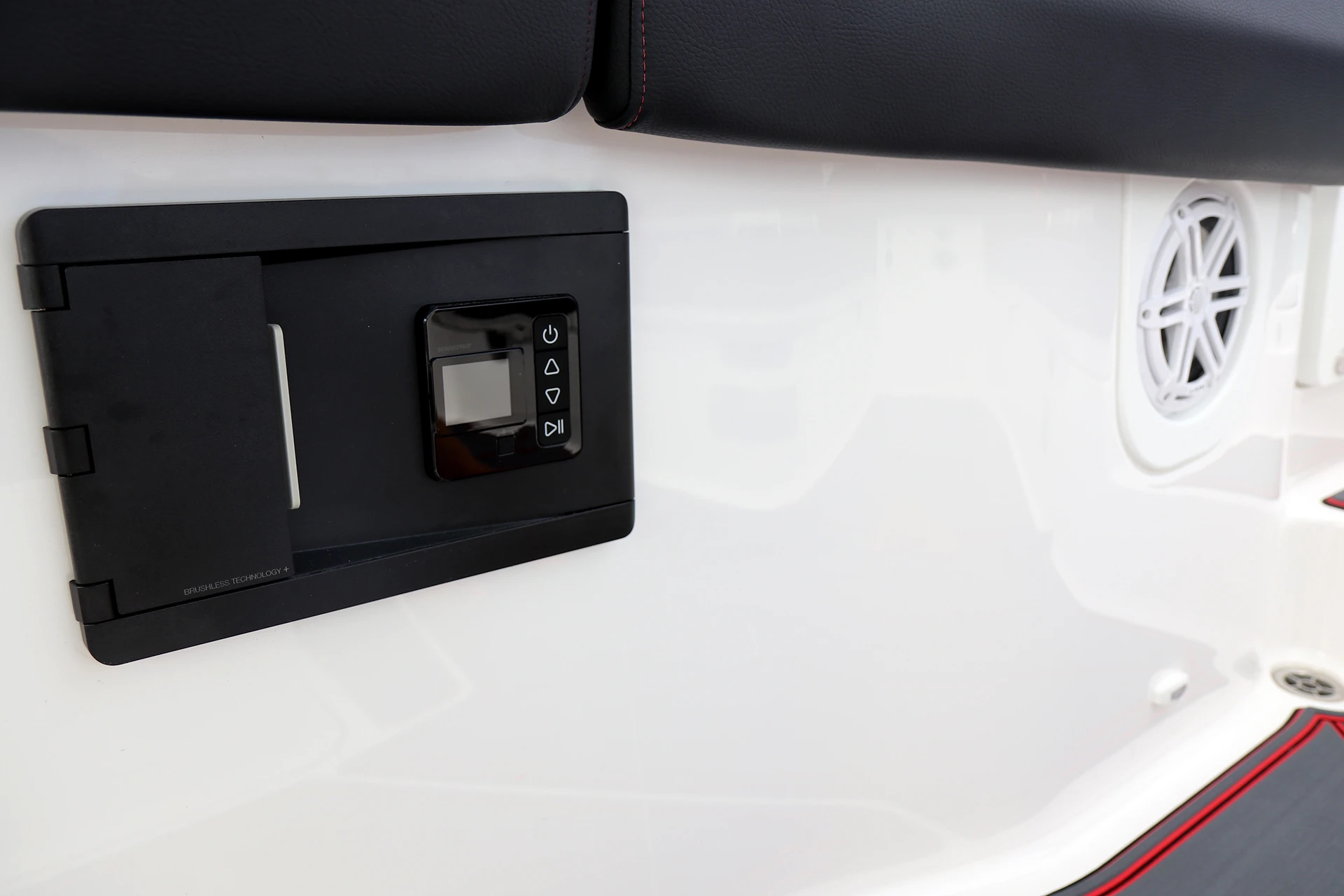 Fusion audio control panel and JL Audio speaker mounted in the cockpit sidewall