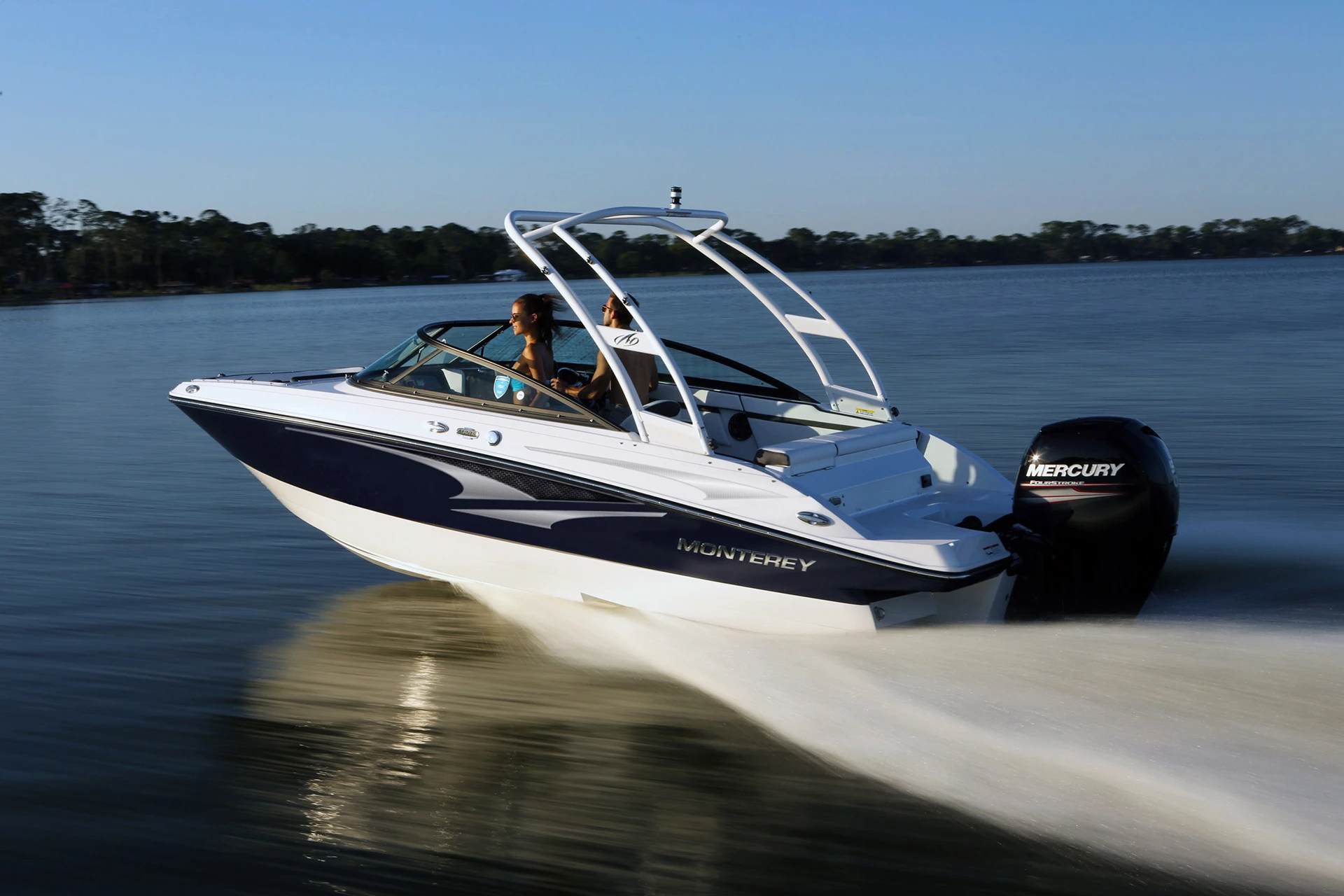 Monterey M-205 running on open water with Mercury outboard engine, side profile view