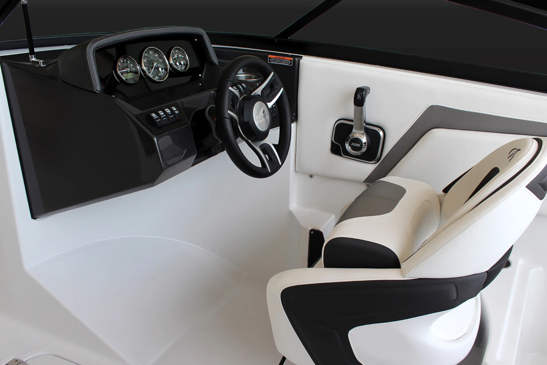 Helm station of the Monterey M-20 showing gauges, steering wheel, and captain’s chair