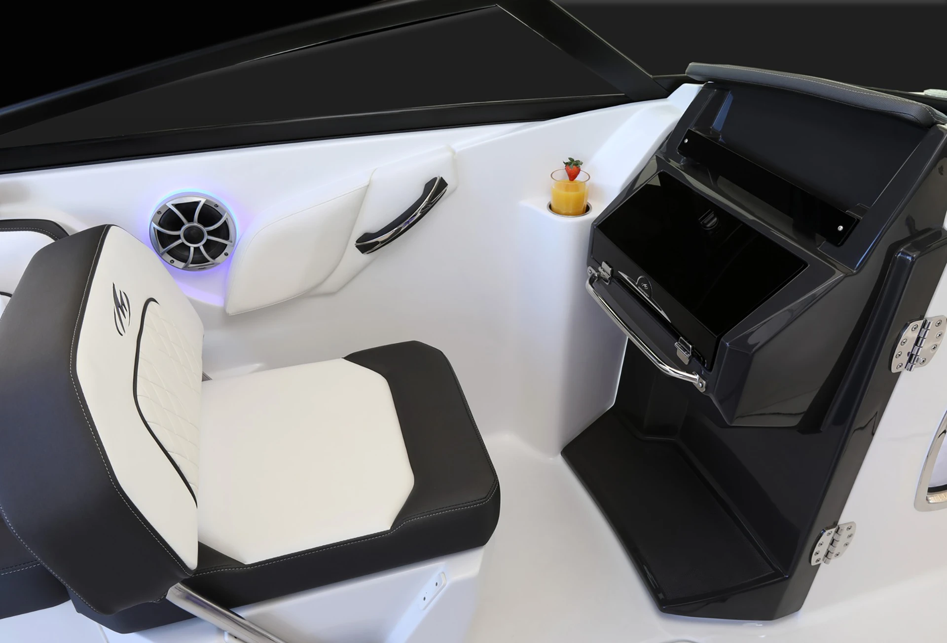 Portside companion seat with diamond-stitched upholstery beside a glovebox and speaker