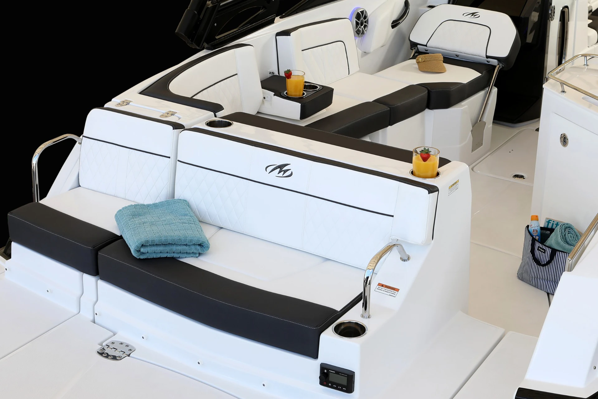 Full cockpit layout showing wraparound seating, helm, galley with sink, and entertainment space