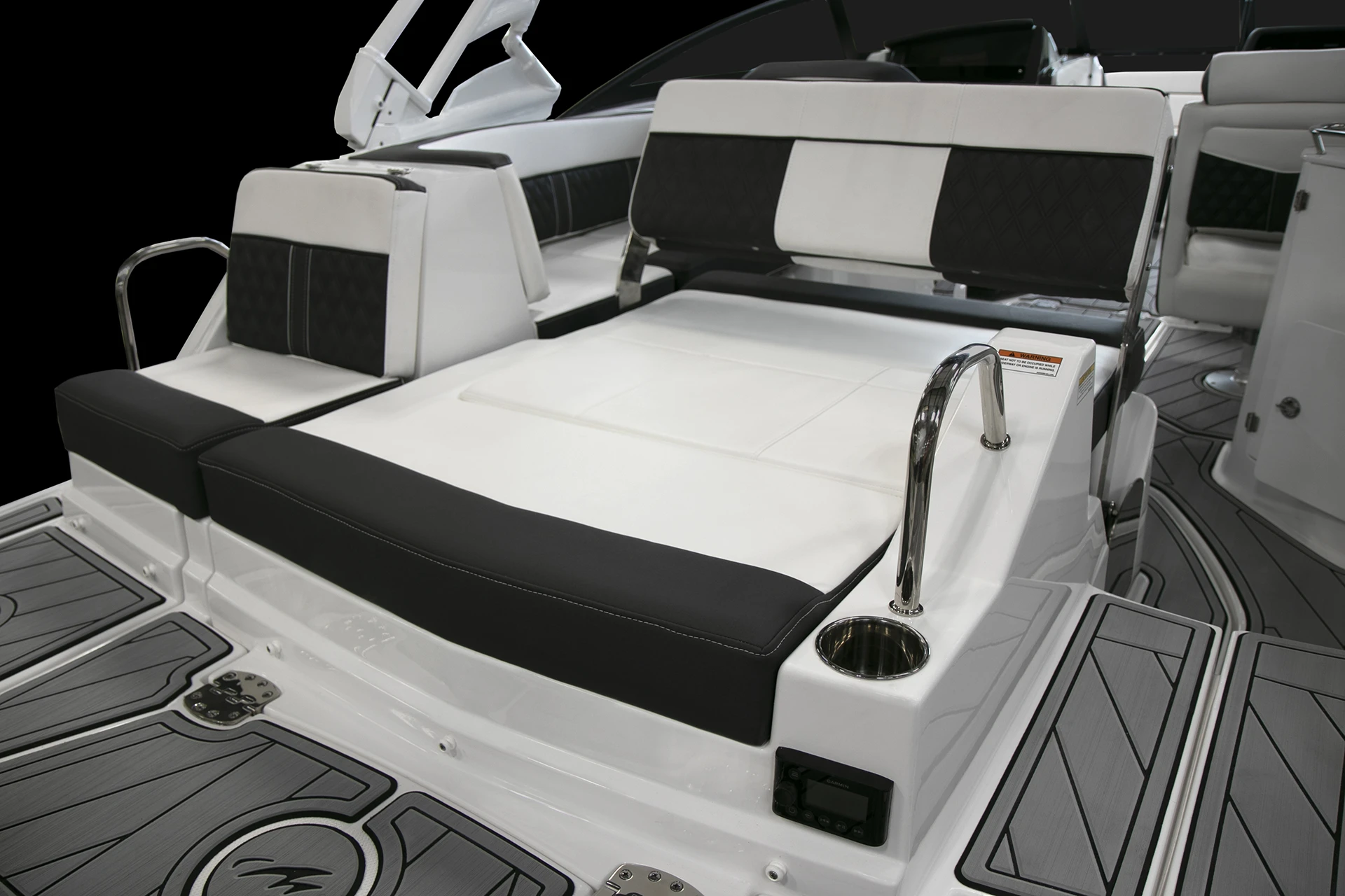 Large stern sunpad with stainless grab rails and cupholders aboard the Monterey M4